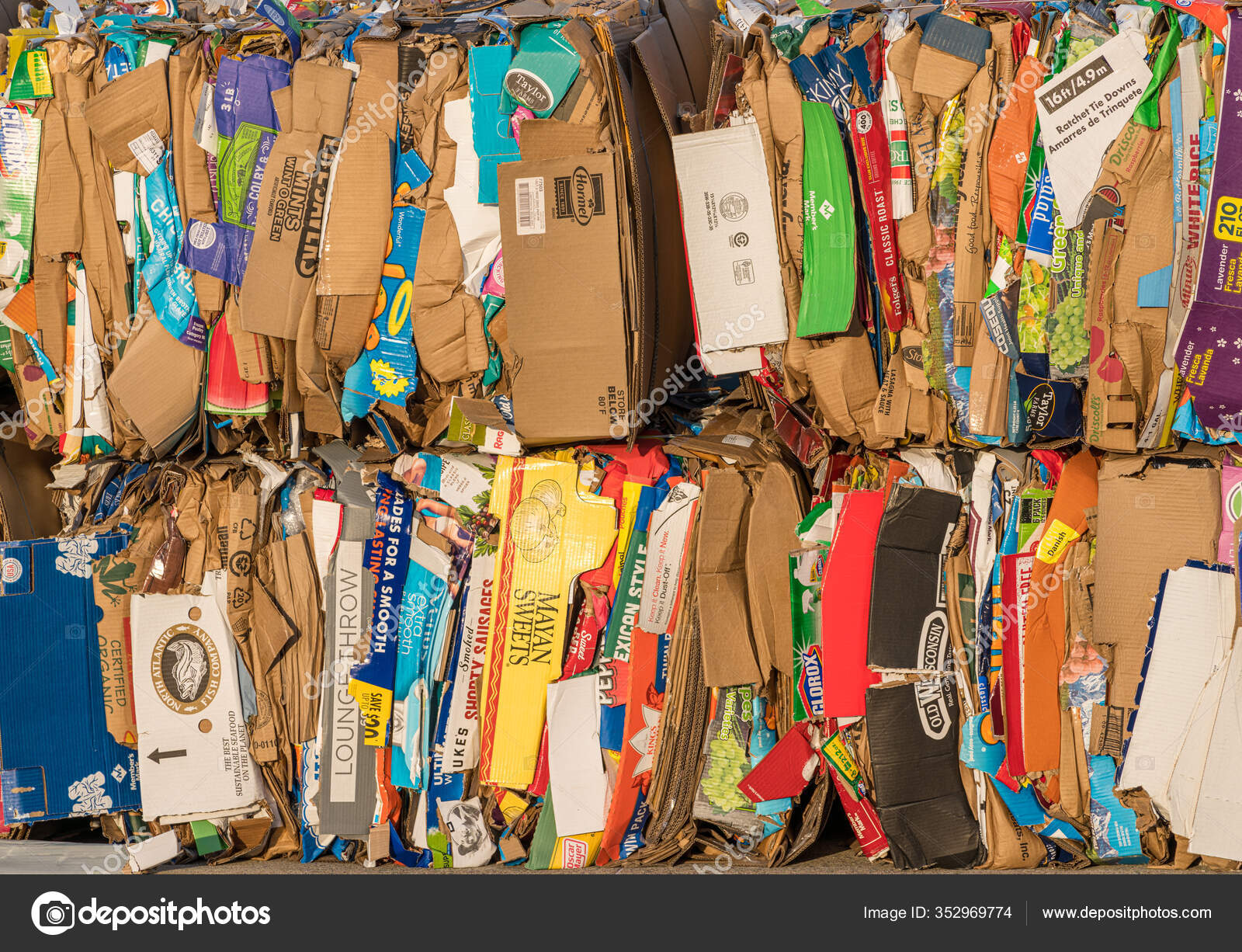 Stacks of folded cardboard boxes ready for recycling behind Walmart