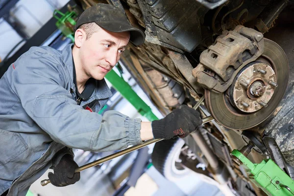 Service de réparation automobile. Mécanicien travaille avec suspension de voiture — Photo