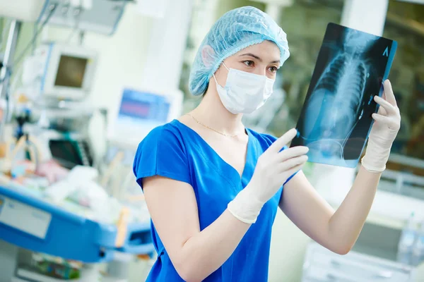 Intensive care unit female doctor with x-ray image — Stock Photo, Image
