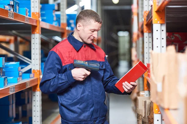 Worker with laser barcode scanner at warehouse — Stock Photo, Image