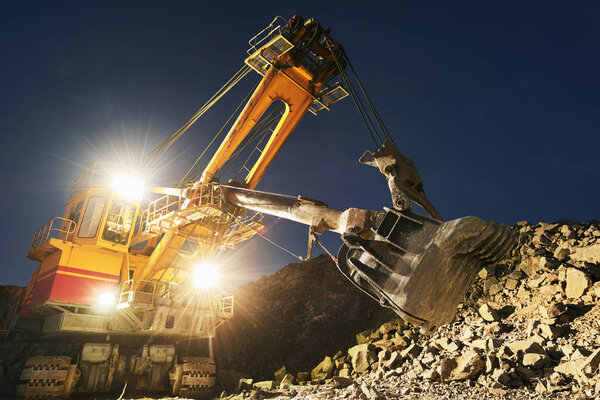 Mining construction industry. Excavator digging granite or ore in quarry
