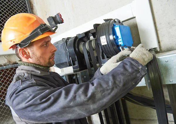 Lift machinist repairing elevator in lift shaft — Stock Photo, Image