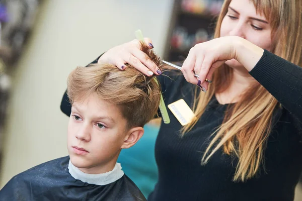 Frisör eller hår stylist på jobbet. Kvinnlig Frisör klippa barnets hår — Stockfoto