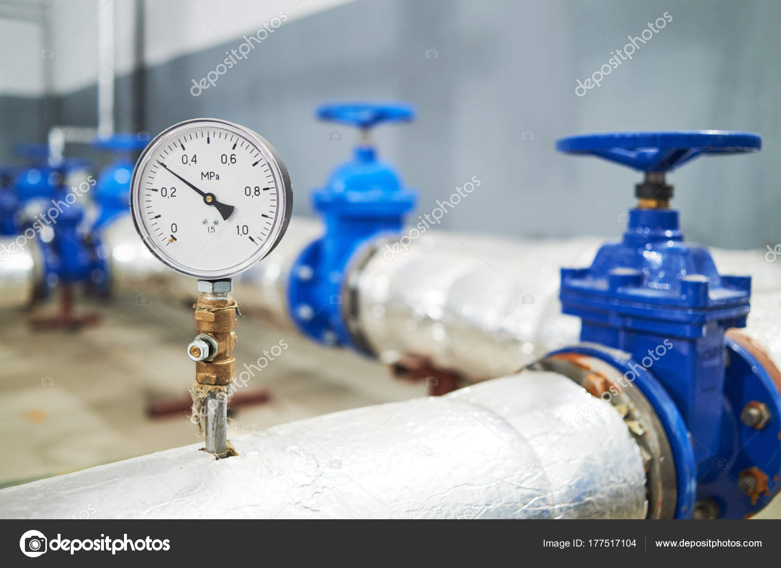 Manometer pipes and valve in water pump station Stock Photo by