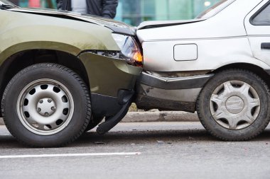 Sokakta araba kazası, şehirde çarpışmadan sonra hasar gören otomobiller