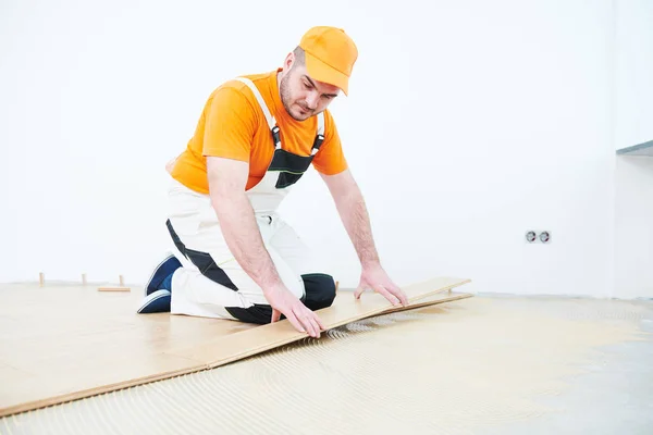 Trabajador uniéndose al suelo de parquet . — Foto de Stock