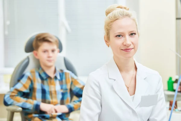 Smiling female doctor or ENT ear nose throat with boy patient in clinic — Stock Photo, Image