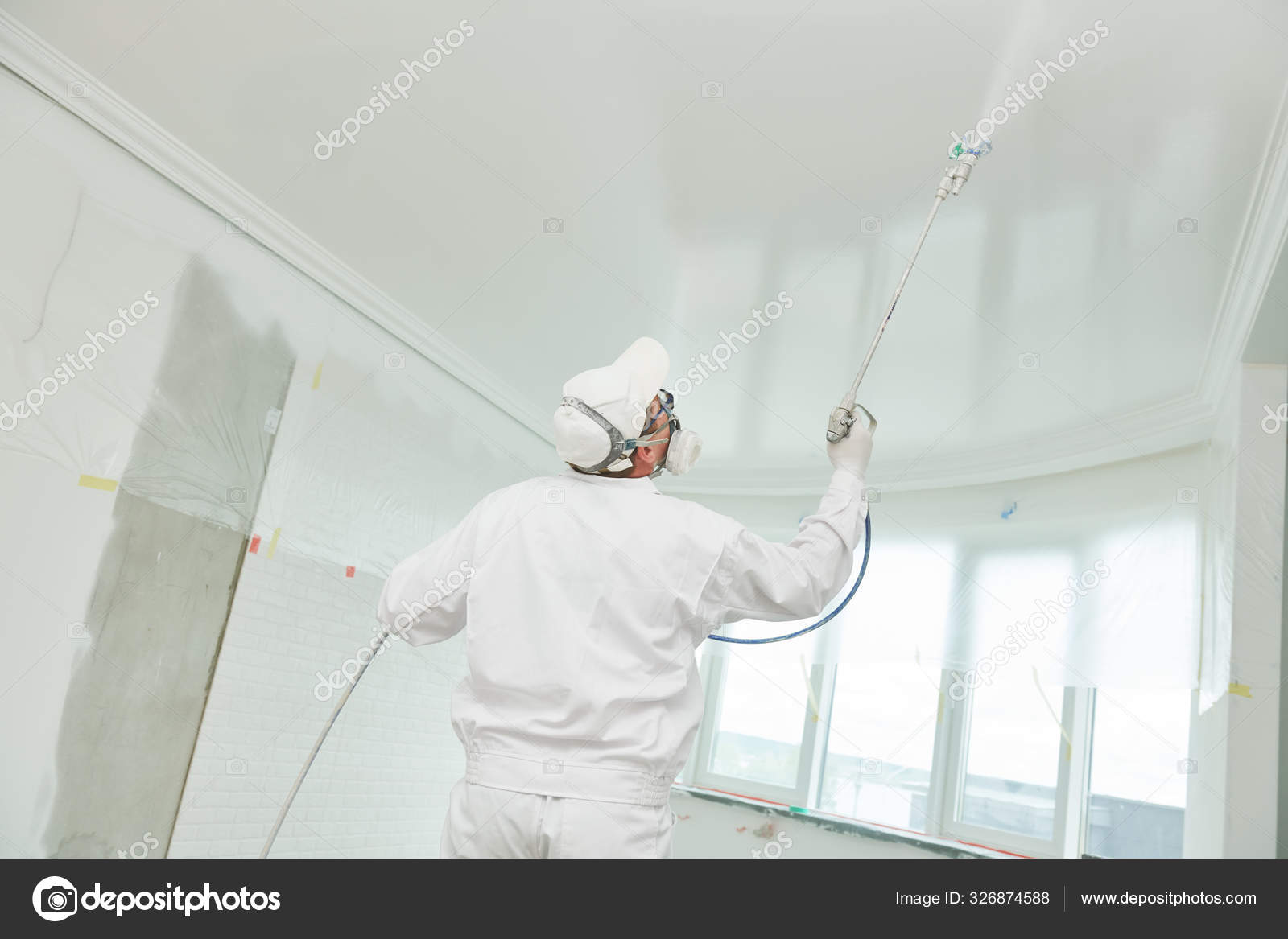 Painter Worker With Airless Painting Sprayer Covering