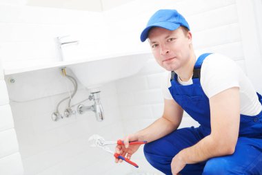 plumber service. Plumber portrait near wash basin siphon installation clipart