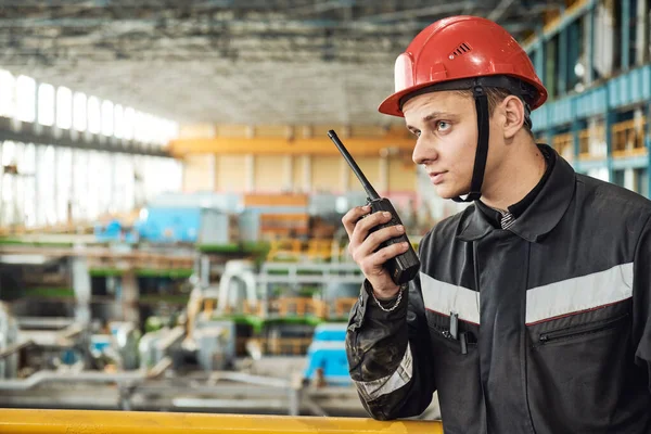 Industrial worker on factory with walkie talkie transmitter — Stock Photo, Image