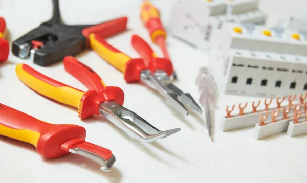 Electrician working tools and circuit breaker before installation in switch box — Stock Photo, Image