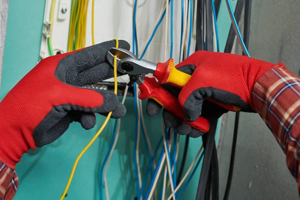 Electrician works with cable wire