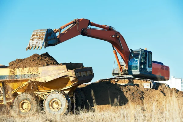 Loader excavator and tipper dumper. earthmoving work — 스톡 사진