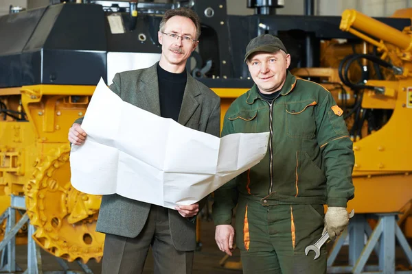 Inginer industrial tehnician cu lucrător la fabrica de fabricație a buldozerelor — Fotografie, imagine de stoc