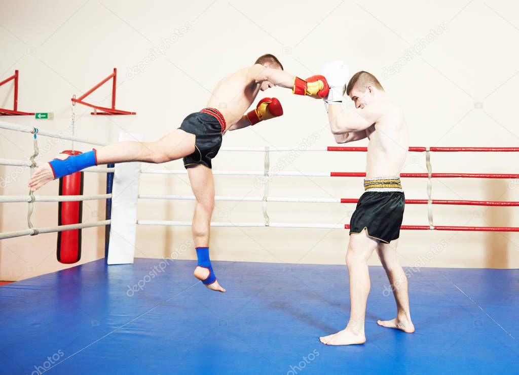 Muay thai sportsman fighting at boxing ring