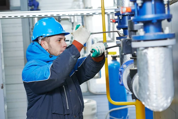 Technician of heating system in boiler room Royalty Free Stock Images