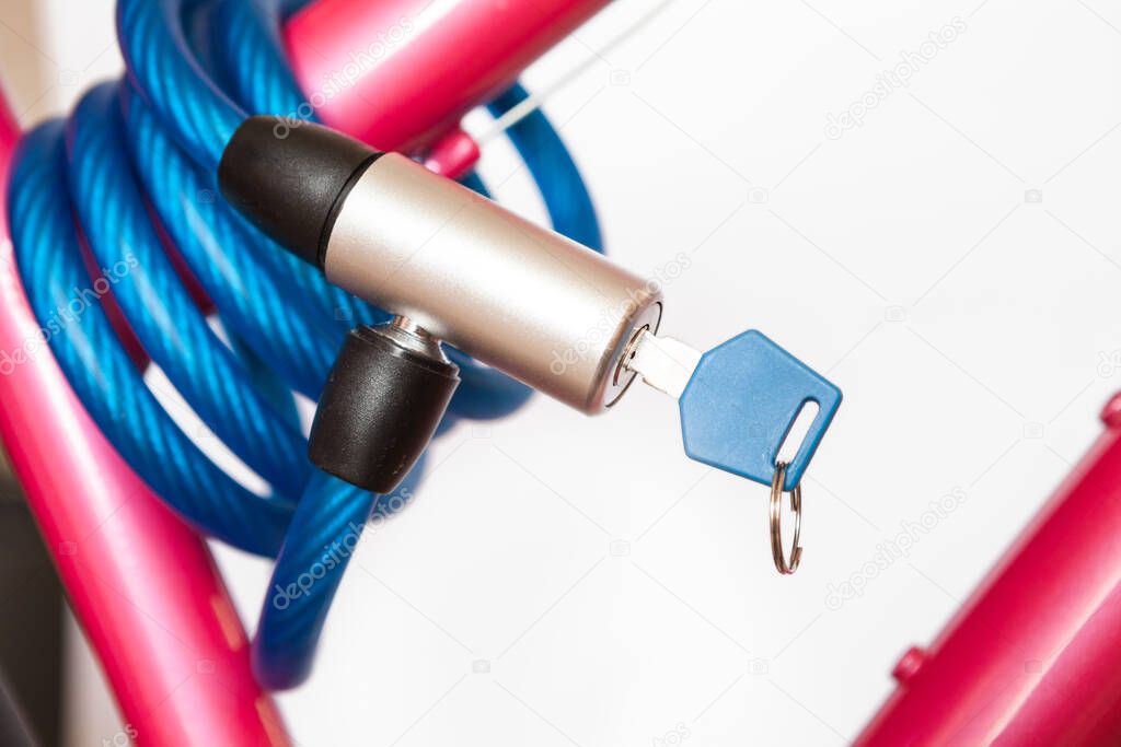Closed cable lock with permanently integrated locking mechanism, looped cable, a white background
