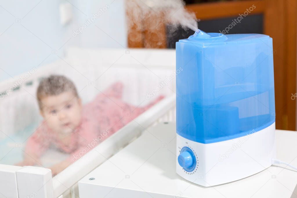 Blue and white humidifier in use. Air humidification for baby comfort sleeping