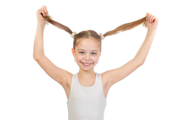 Young cute smiling girl with grey blue eyes and two hair tails in hands  isolated on white background