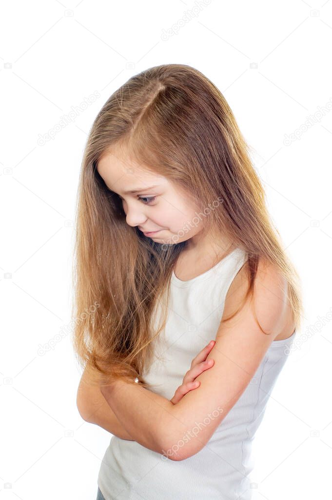 Young cute sad girl with grey blue eyes, long light brown hair and crossed arms isolated on white background