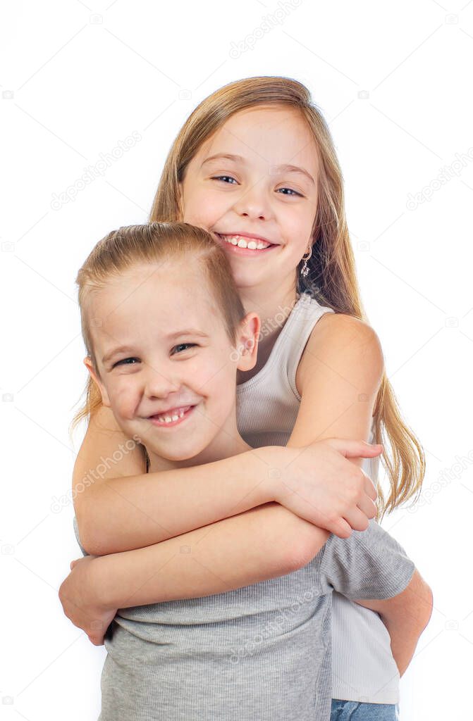 Young smiling caucasian girl and boy hugging isolated on white backgroundboy