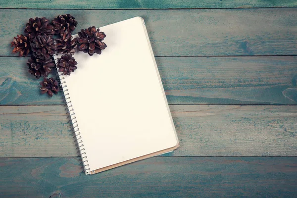 Caderno em branco com cones de pinheiro — Fotografia de Stock