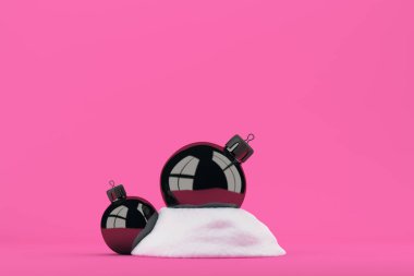 İki Noel topları parlak pembe bir arka plan üzerinde