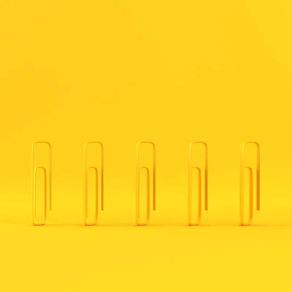 Paper clips on yellow background with copy space — Stock Photo, Image