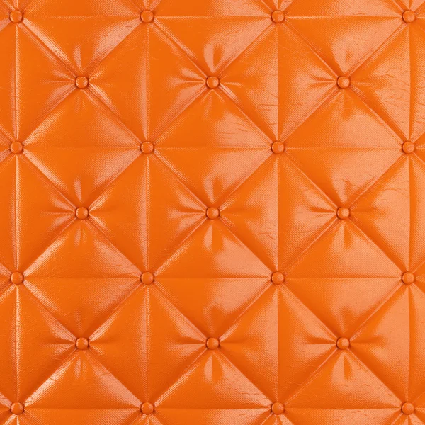 Stock image Stitched upholstery leather orange background with buttons