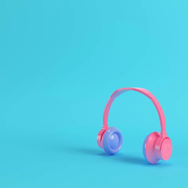 Pink headphones on bright blue background in pastel colors — Stock Photo, Image