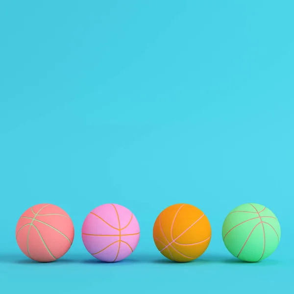 Quatro bolas de basquete em fundo azul brilhante em cores pastel — Fotografia de Stock