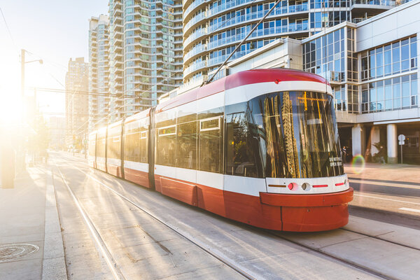Modern tram in Toronto downtown at sunset