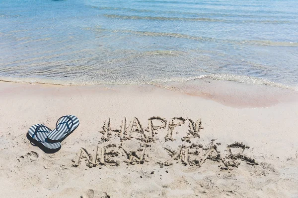 Happy new year writing on the sand — Stock Photo, Image