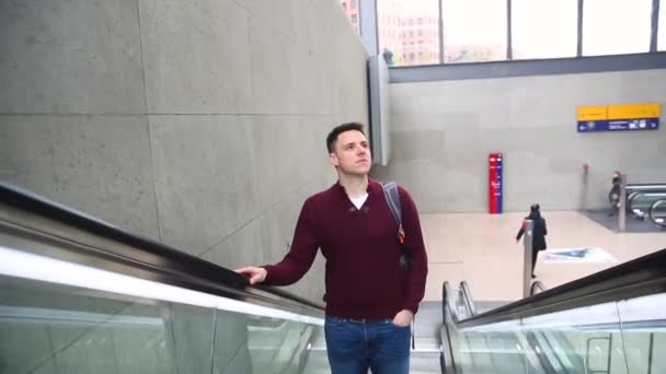 Young man on the escalator — Stock Video