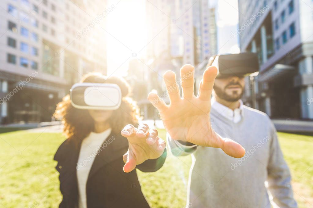 Business woman and man wearing virtual reality headset