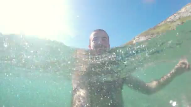 Hombre nadando y divirtiéndose en el agua en verano — Vídeos de Stock