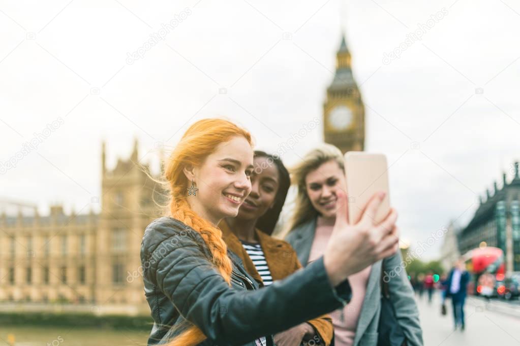 Girls taking a selfie with Big Ben in London 