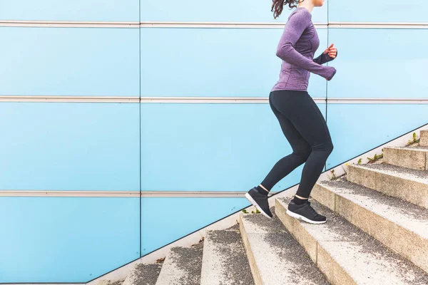 Woman jogging and running up a staircase — Stock Photo, Image