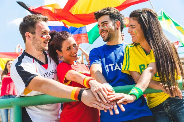 Happy fans supporters from different countries together at stadi — Stock Photo, Image