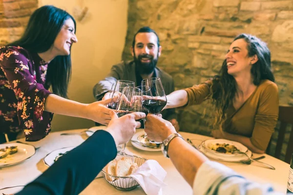 Gente che brinda con vino rosso al ristorante — Foto Stock