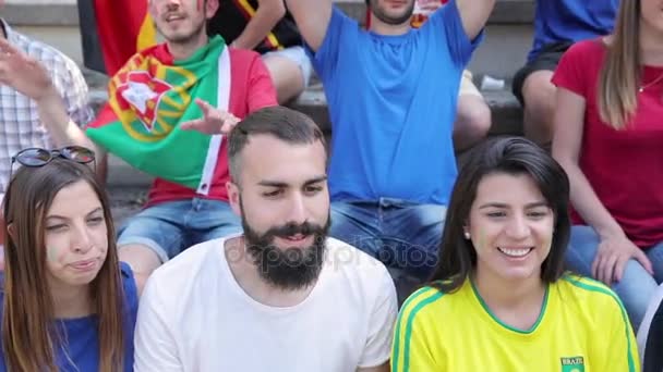 Happy fans supporters from different countries together at stadium — Stock Video