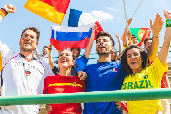 Happy fans supporters from different countries together at stadi — Stock Photo, Image