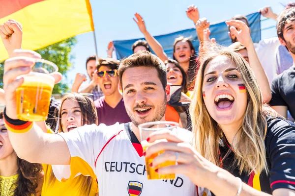 German supporters celebrating at stadium and drinking beer — Stock Photo, Image
