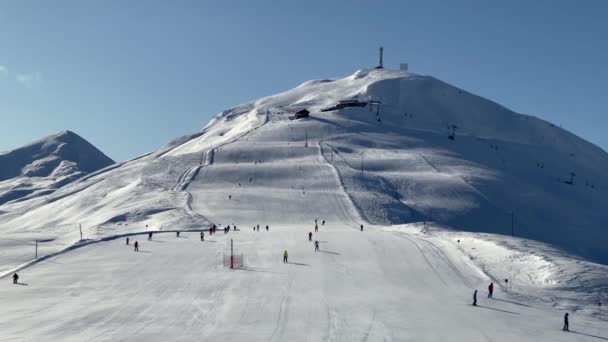 People skiing on snowy slope at ski resort in the mountains — Stock Video