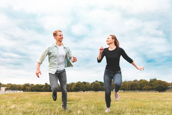 Happy couple running and having fun together at Tempelhof  park — Zdjęcie stockowe