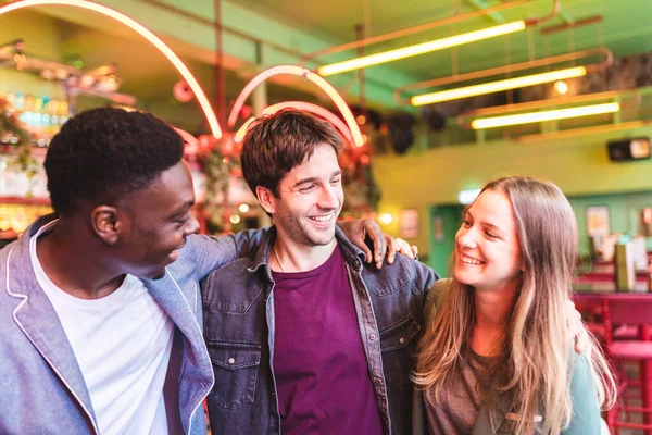 Happy multiracial friends having fun at bar — Stockfoto