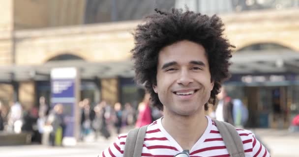 Man portrait in front of busy train station in London — Stock Video