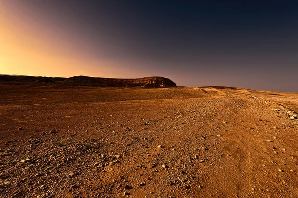 Rocky hills of the Negev desert in Israel at sunset. Wind carved rock formations in the Southern Israel Desert.