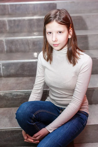 Girl sitting on stairs — Stock Photo, Image