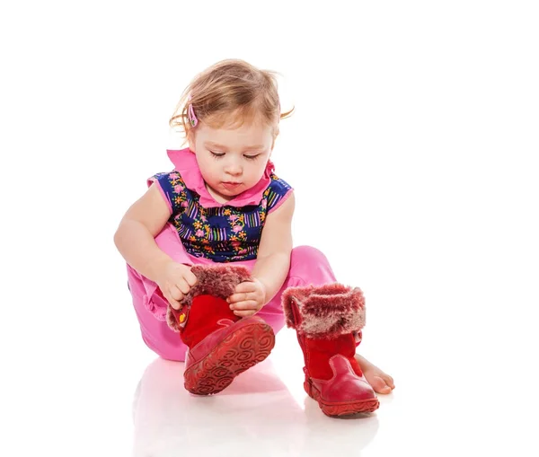 Toddler putting on shoes Stock Photo by ©olgasweet 174897966